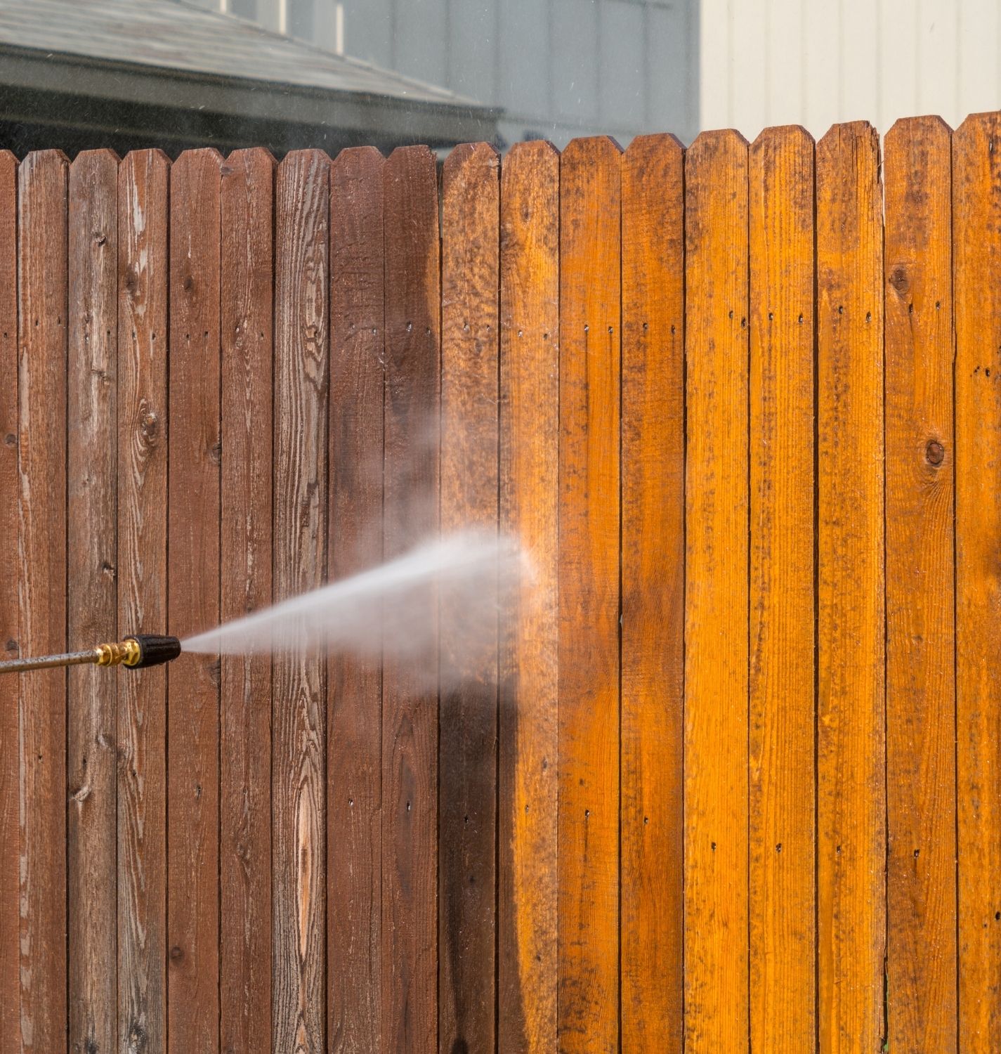 Low-pressure soft-washing an exterior wood fence in the Sacramento area